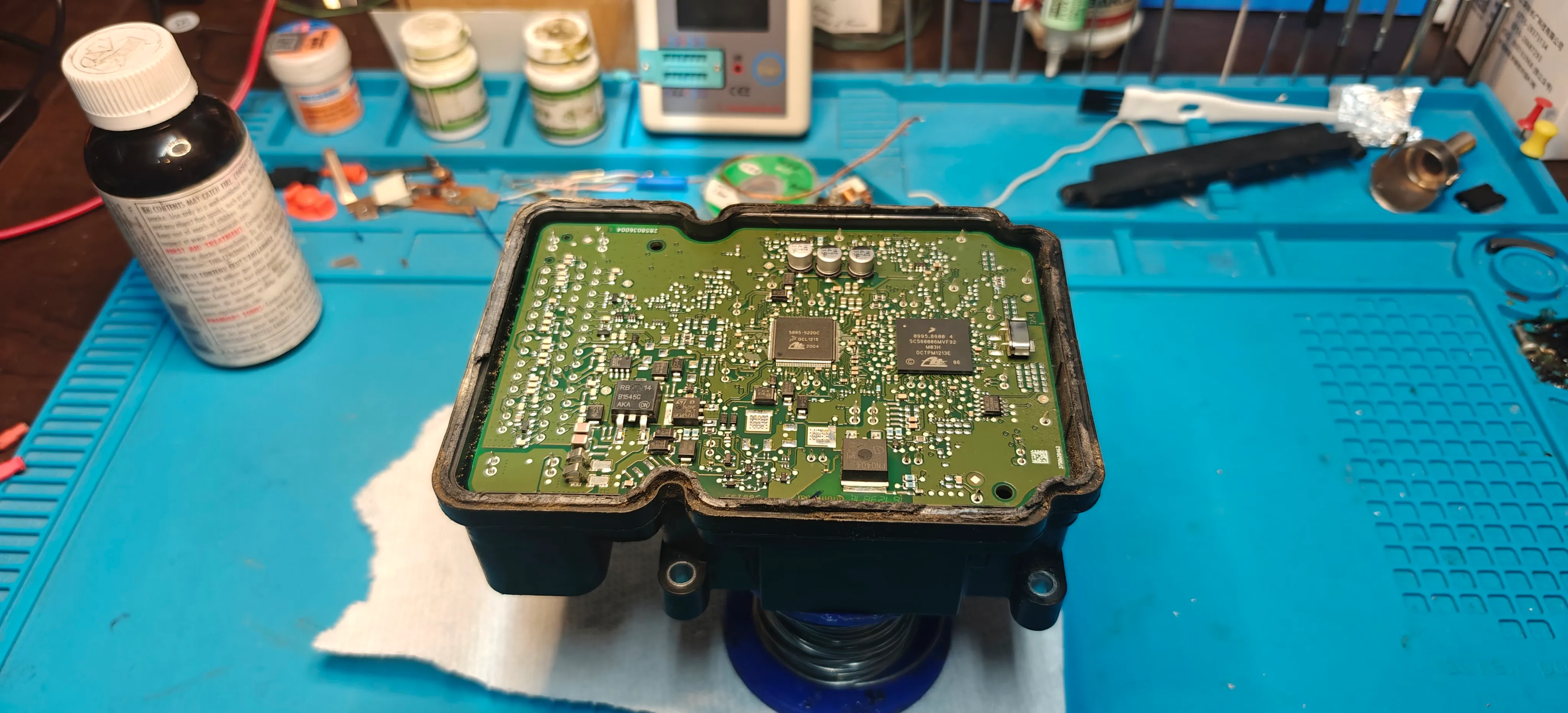 ABS module opened on the workbench for board-level repair at Module Masters Calgary