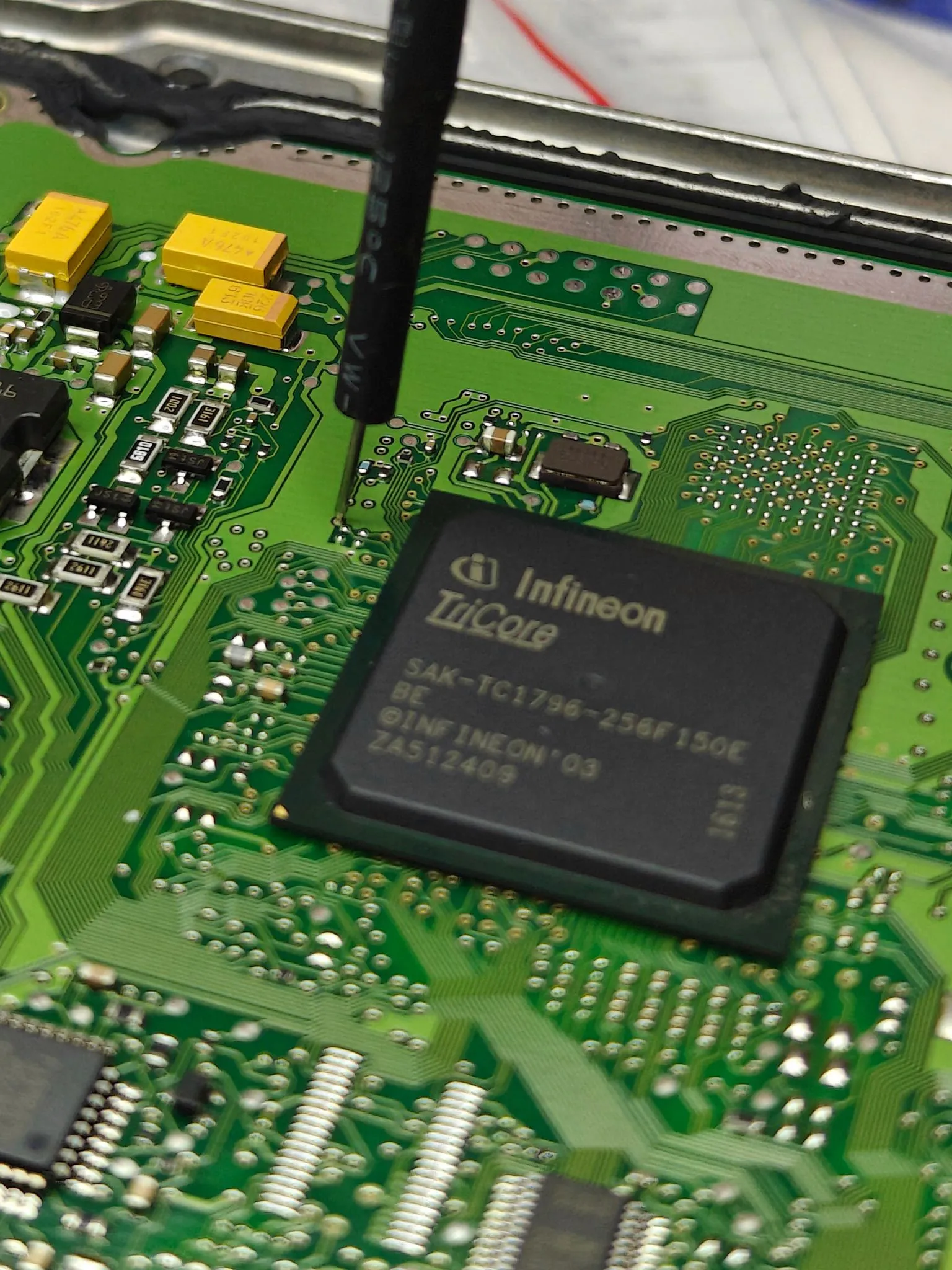 Engine control unit (ECU) on the bench during board-level repair and programming